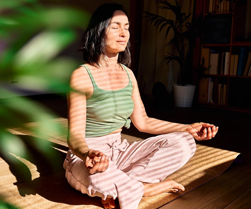 a young woman practices meditative breathing exercises